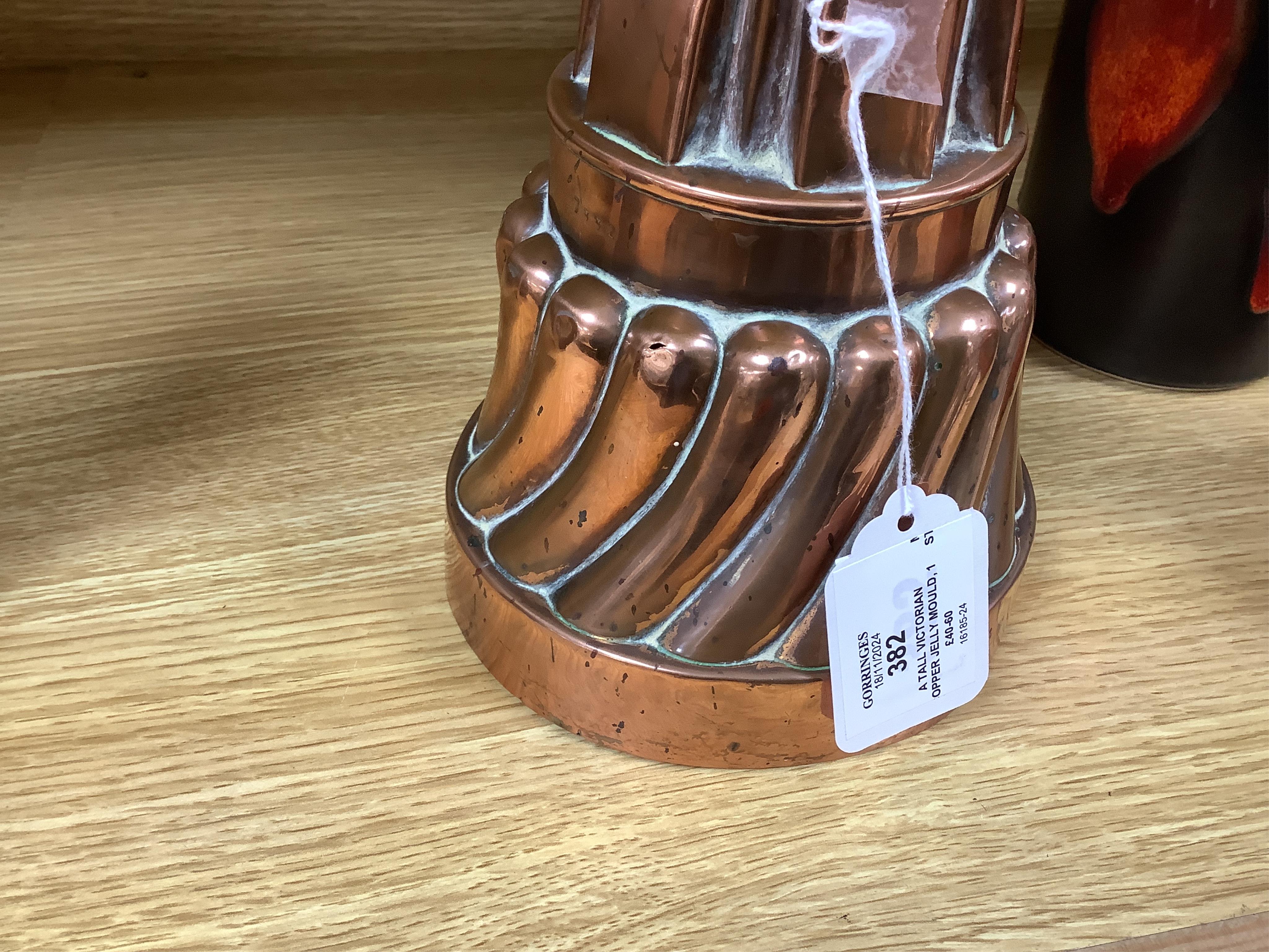 A tall Victorian copper jelly mould, 17cm. Condition - fair
